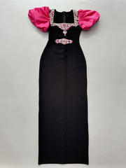 Black evening gown with pink sleeves on a gray background