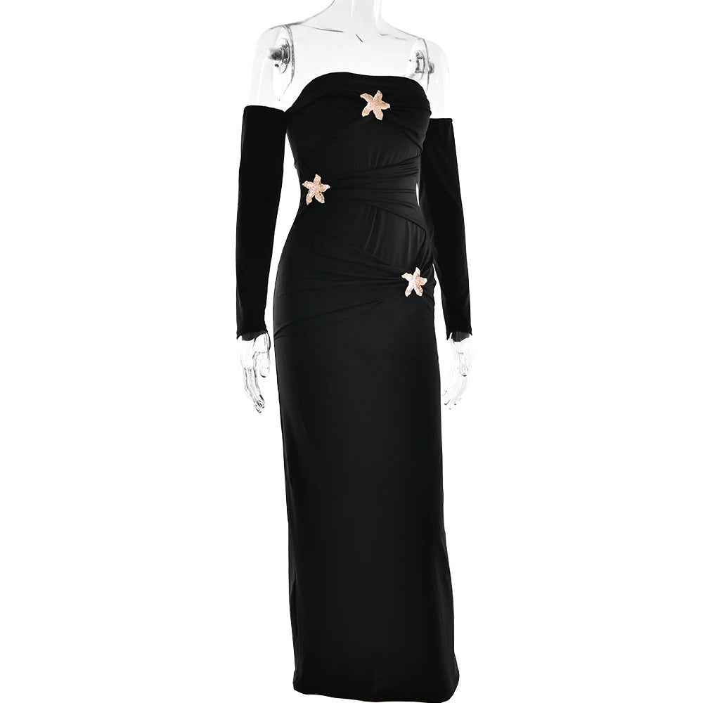 Black evening gown with gold embellishments on a mannequin against a white background