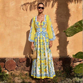 Woman wearing a yellow and blue print long sleeve bodysuit and maxi skirt.