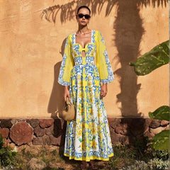 Woman wearing a yellow and blue print long sleeve bodysuit and maxi skirt.
