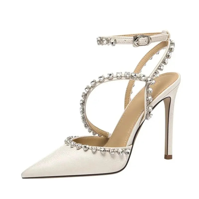 White high-heeled shoe with crystal embellishments on a white background