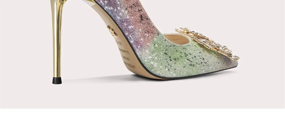 Sparkly high-heeled shoe with gold accents on a light background