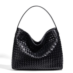 Black woven handbag on a white background