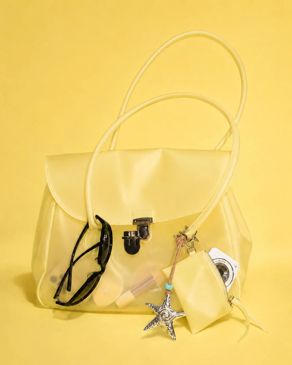 Yellow transparent tote bag with accessories