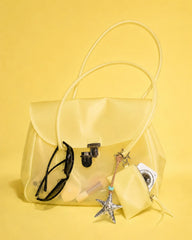 Yellow transparent tote bag with accessories