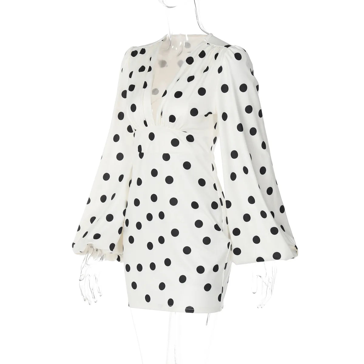 White blouse with black polka dots on a white background