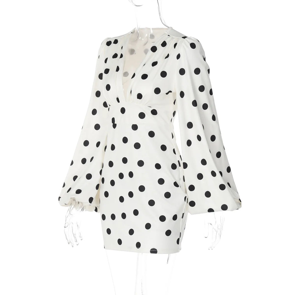 White blouse with black polka dots on a white background