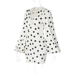 White blouse with black polka dots on a white background