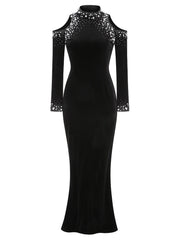 Black evening gown with sheer sleeves and embellishments on a white background