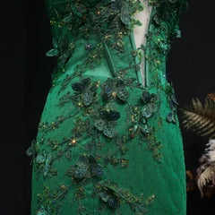 Green embroidered garment with intricate detailing on a dark background