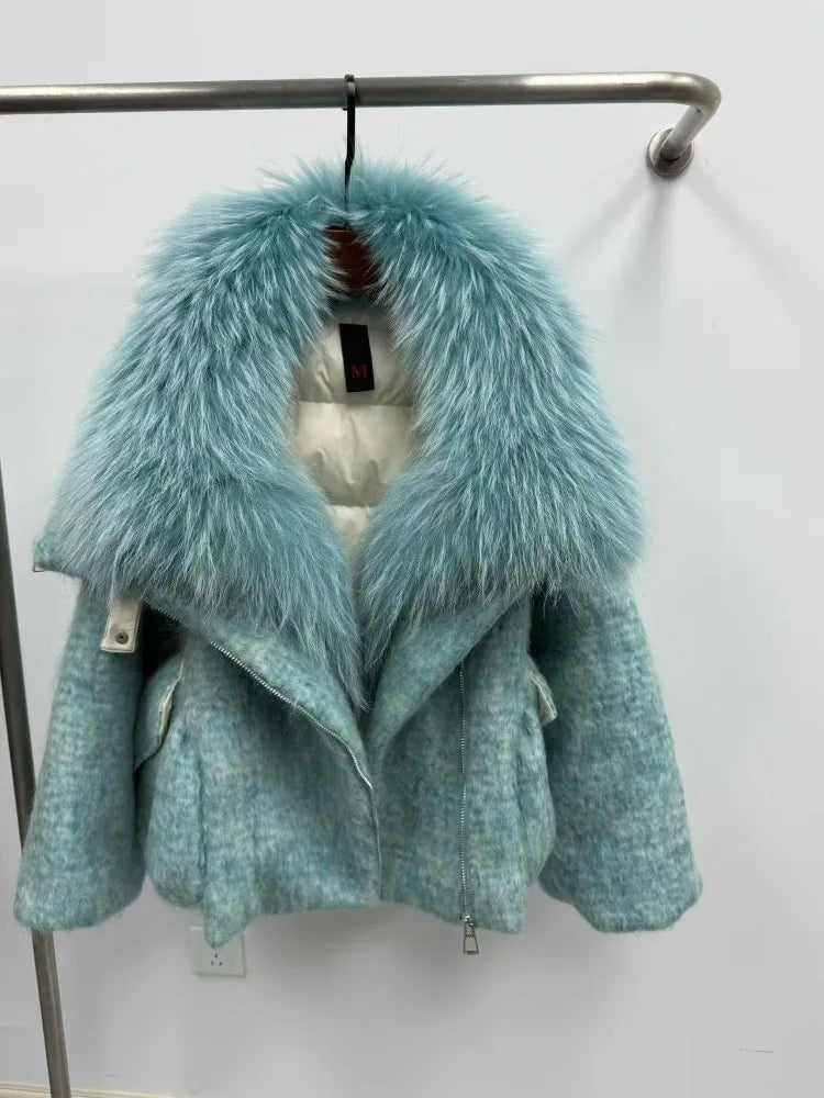 Teal coat with fur hood on a rack against a white background