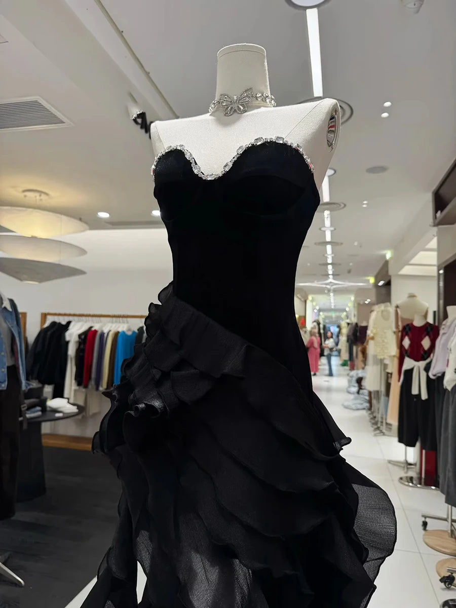 Black evening gown on a mannequin in a store setting