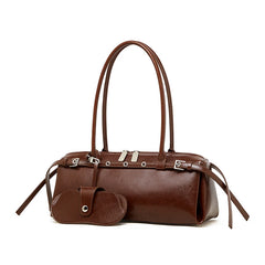 Brown leather handbag with multiple straps on a white background