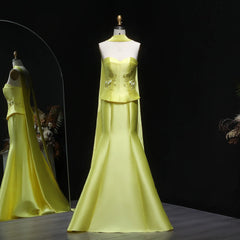 Yellow evening gown on a mannequin against a dark background