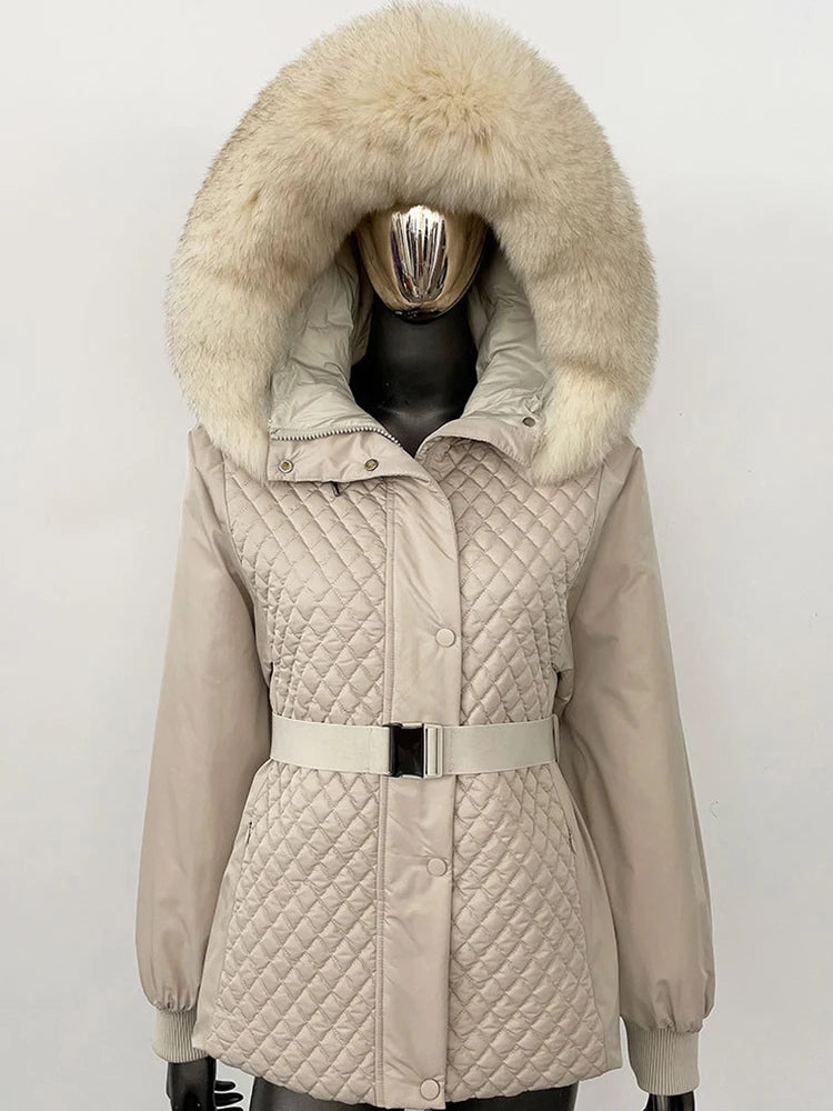 Beige quilted jacket with a large fur hood on a mannequin against a white background