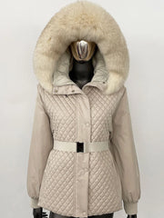 Beige quilted jacket with a large fur hood on a mannequin against a white background
