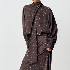 Brown polka dot dress on a plain background