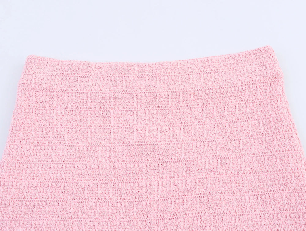 Close-up of a pink textured fabric on a light gray background