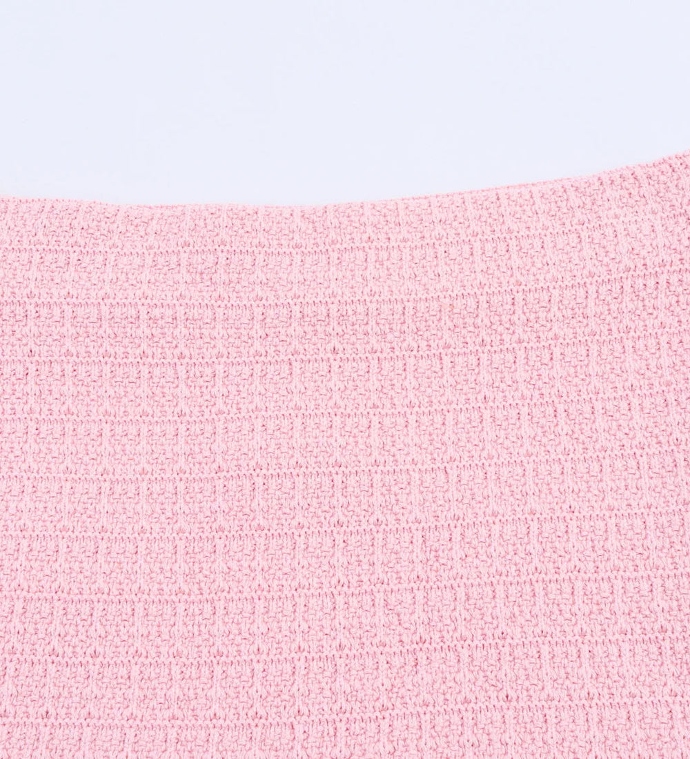 Close-up of a pink textured fabric on a light gray background
