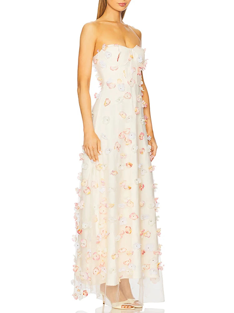 White strapless gown with floral embellishments on a white background