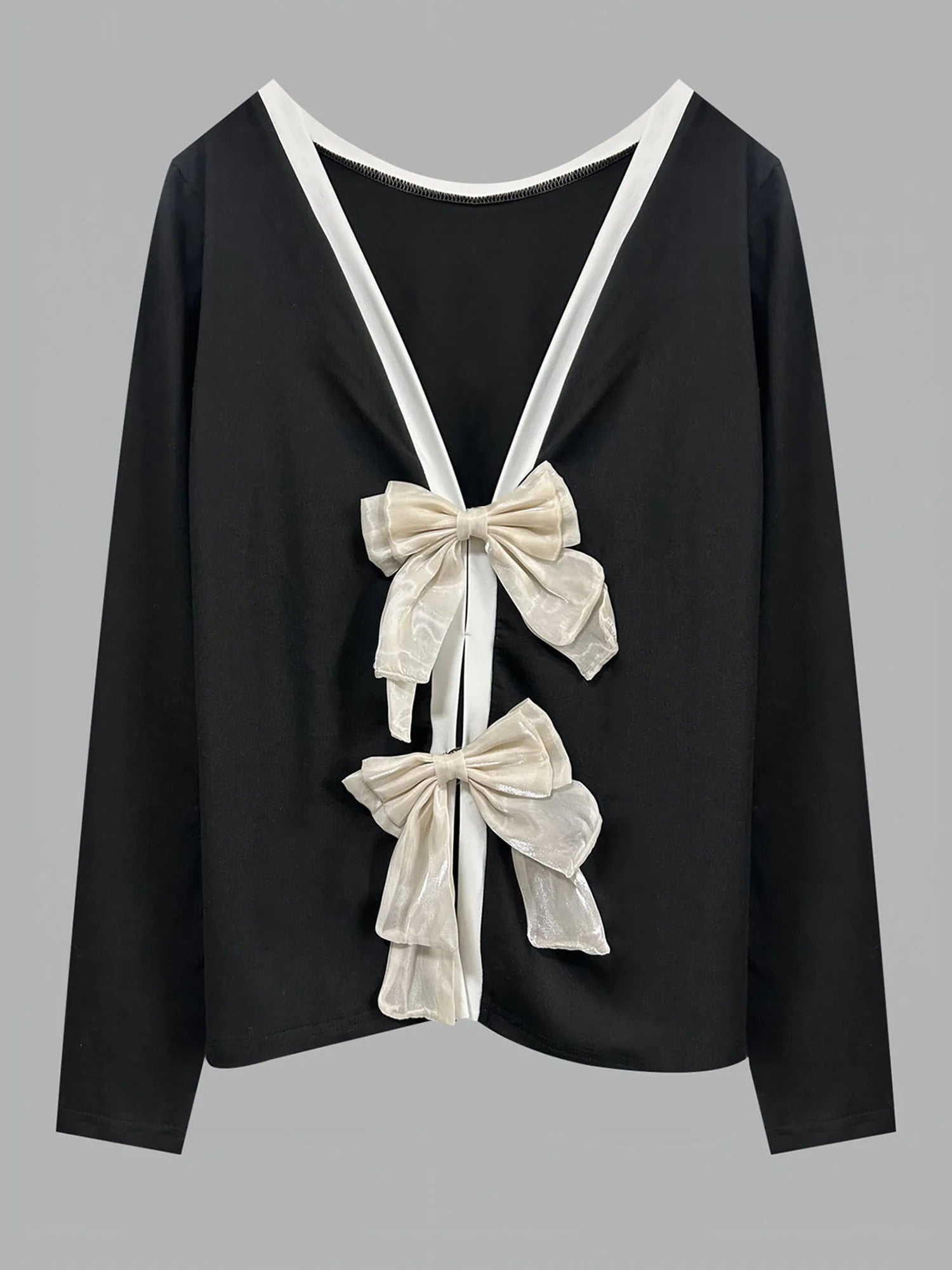 Black top with white bows on a gray background