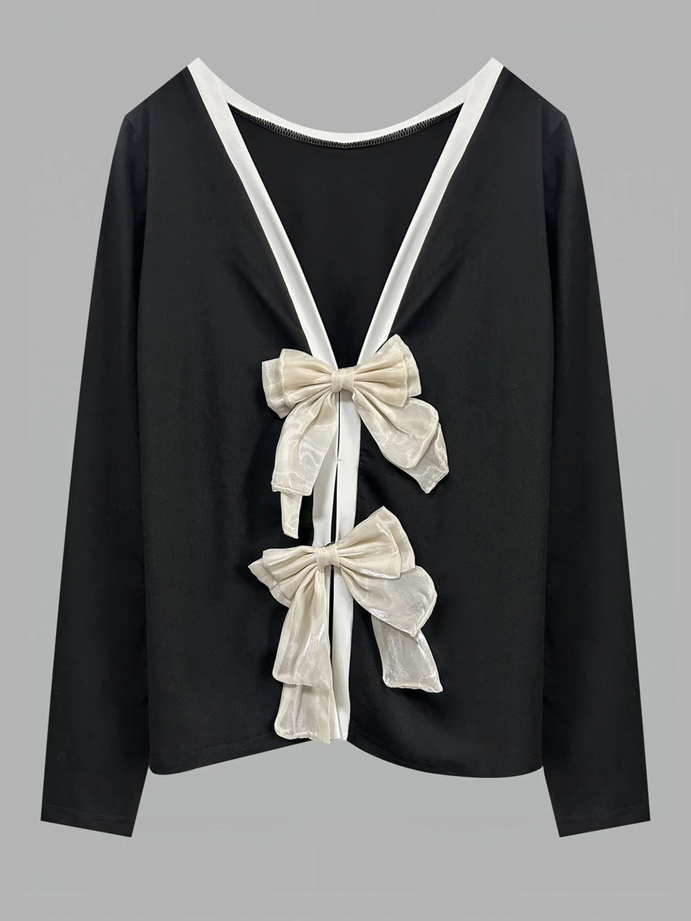 Black top with white bows on a gray background