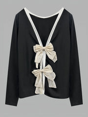 Black top with white bows on a gray background