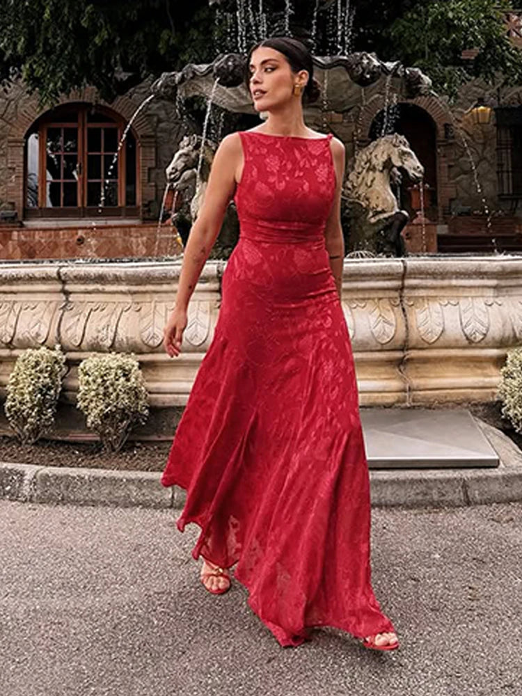 Woman in a red dress standing in front of a fountain