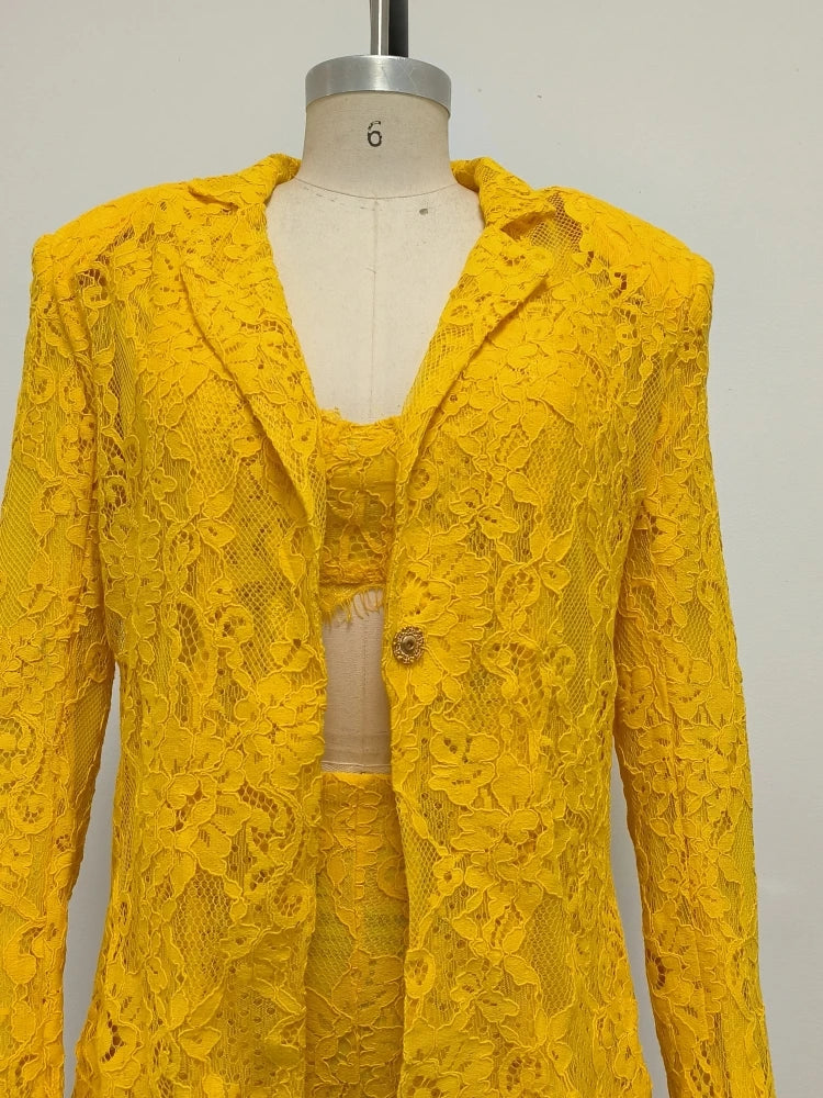 Yellow lace outfit on a mannequin against a plain background