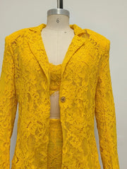 Yellow lace outfit on a mannequin against a plain background