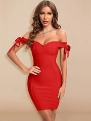 Woman wearing a red off-shoulder dress with bow details on a beige background