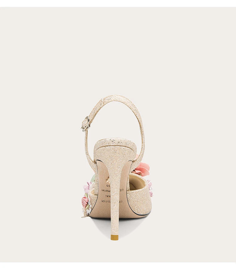 High-heeled shoe with floral details on a white background