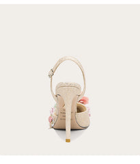 High-heeled shoe with floral details on a white background