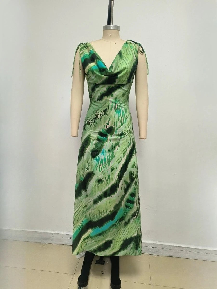 Green patterned dress on a mannequin against a white background