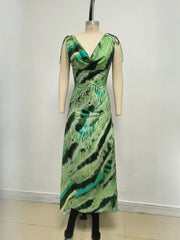 Green patterned dress on a mannequin against a white background