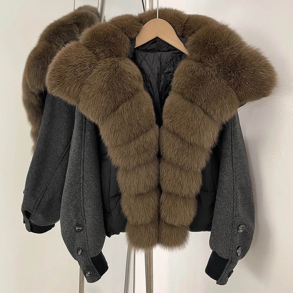 Gray jacket with brown fur collar on a hanger against a white background