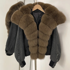 Gray jacket with brown fur collar on a hanger against a white background