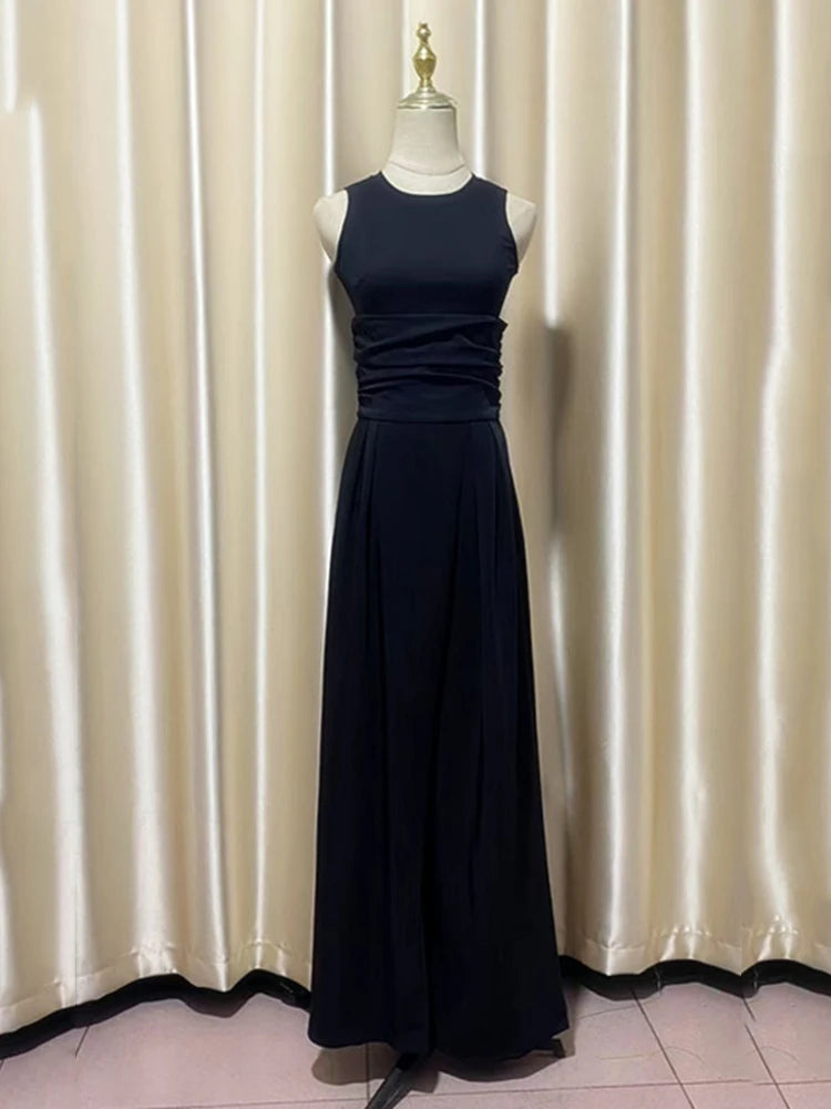 Navy blue evening outfit on a mannequin against a beige curtain background