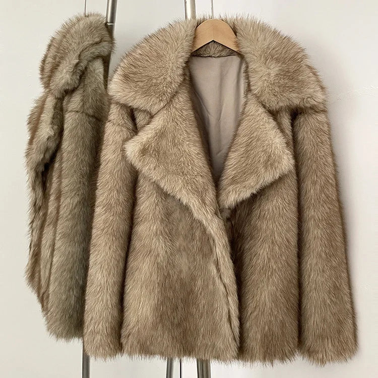 Beige faux fur coat on a hanger against a white background