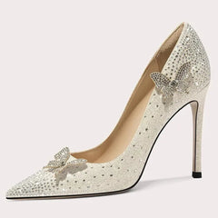 Silver high-heeled shoe with bow detail on a white background