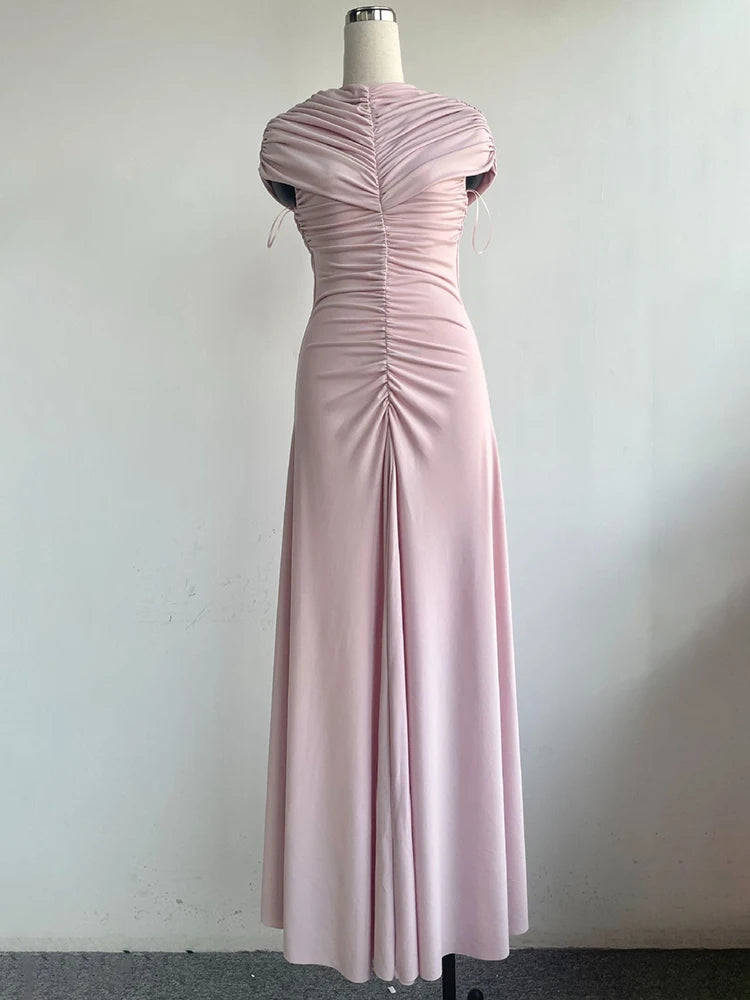 Pink evening gown on a mannequin against a white background