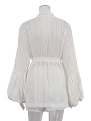 White pleated blouse on a mannequin with a white background