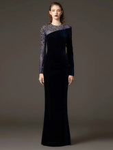 Velvet sheath gown with beaded mesh sleeves styled for evening wear
