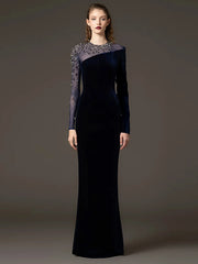 Velvet sheath gown with beaded mesh sleeves styled for evening wear