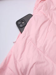 Pink quilted jacket with a black phone on a light gray background