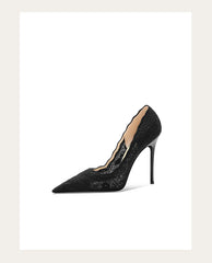 Black high-heeled shoe with a pointed toe on a white background
