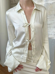 Close-up of ivory satin tie front top neckline