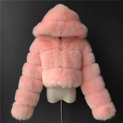 Pink fur coat on a mannequin against a black background