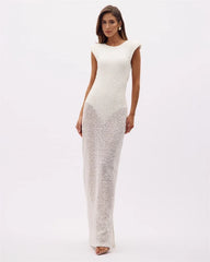 Full body shot of a white sequined backless gown dress.