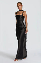 Woman wearing a black evening gown with a sheer side panel